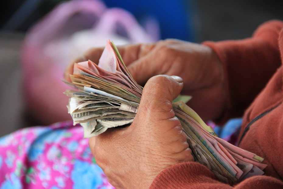 person holding Vietnam banknotes